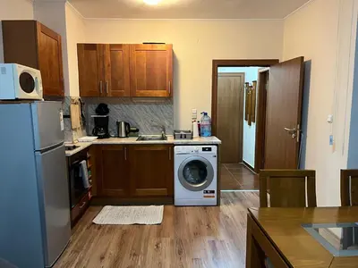 a kitchen with a washing machine in a kitchen at Ski Zone at Gondola, Warm and Cosy, WiFi, AC, Netflix, Perfect One Bedroom appartment, Beautiful View in Bansko