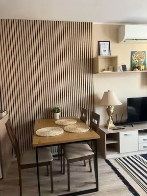 a dining room with a table and chairs and a wall at Paradise dreams Velingrad in Velingrad