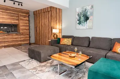 a living room with a couch and a table at Kleptuzaparts in Velingrad