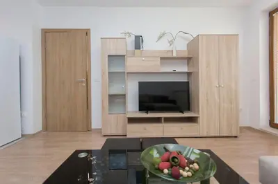 a living room with a television and a table at Modern and Bright Apartments near Center - FREE PARKING in Sofia