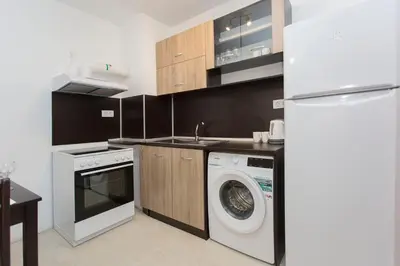 a kitchen with a washing machine and a refrigerator at Modern and Bright Apartments near Center - FREE PARKING in Sofia