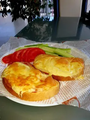 a plate of food with bread and vegetables on a table at Хотел Дани in Sandanski