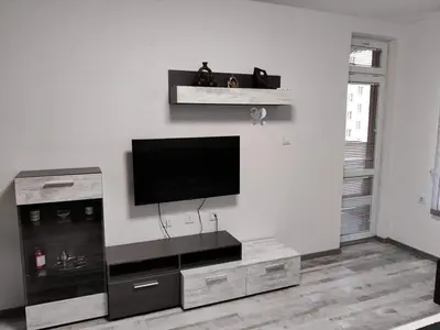 a living room with a flat screen tv on a wall at Apartment Anelia 3 in Plovdiv