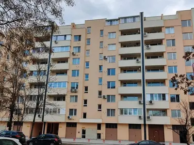 an apartment building with cars parked in front of it at Apartment Anelia 3 in Plovdiv