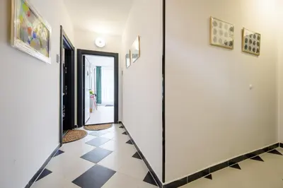 a hallway with a black and white tiled floor at Retro Studio byPMM in Plovdiv