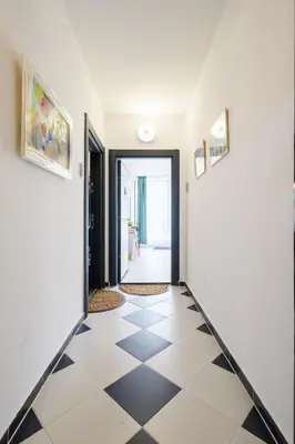a hallway with a black and white checkered floor at Retro Studio byPMM in Plovdiv