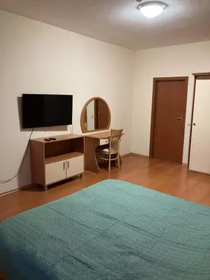 a bedroom with a bed and a desk with a television at Flora Apartment 613 in Borovets