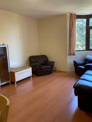 a living room with a couch and a tv at Flora Apartment 613 in Borovets
