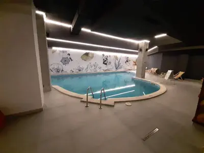 a swimming pool in the middle of a room at Flora Apartment 613 in Borovets