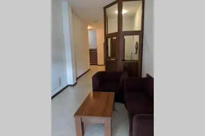 a living room with two chairs and a table at Large Gondola Apartment - Center, Neon in Bansko