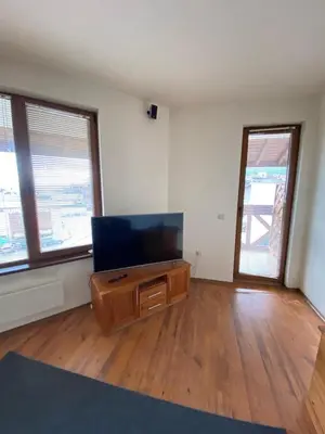 an empty living room with a flat screen tv at Large Gondola Apartment - Center, Neon in Bansko