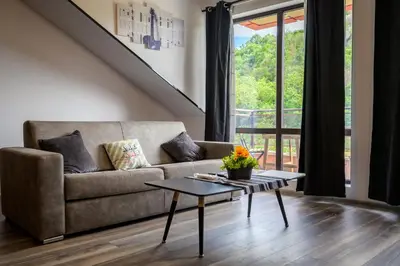 a living room with a couch and a table at Urban Music Studio byPMM in Plovdiv