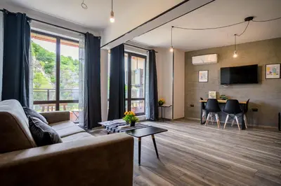 a living room with a couch and a table at Urban Music Studio byPMM in Plovdiv