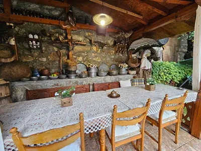 a dining room with a table and chairs at Hotel Rai in Koprivshtitsa