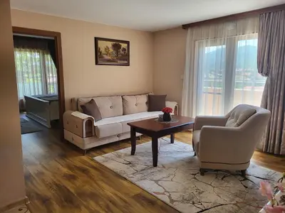 a living room with a couch and chairs and a table at Студио Лидия in Velingrad