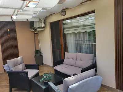a living room with a couch and chairs and a table at Студио Лидия in Velingrad