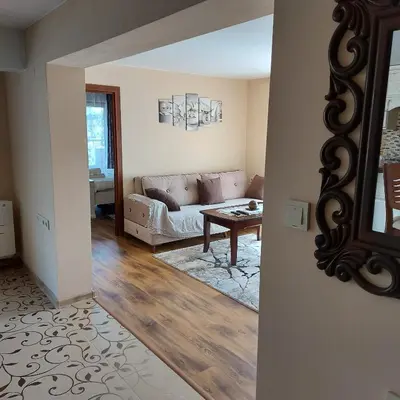 a living room with a couch and a table at Студио Лидия in Velingrad