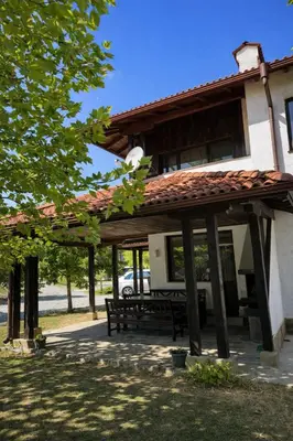 a patio with a bench in front of a house at Марковската къща in Oreshak