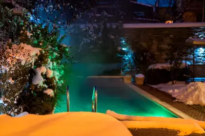a swimming pool covered in snow at night at Villa Vuchev in Velingrad