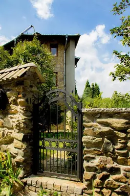 a gate to a house with a stone wall at Villa Pontica in Sofia