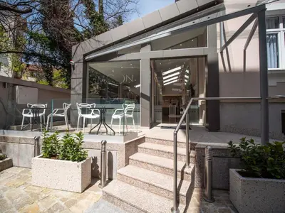 a glass house with stairs and a table and chairs at The Moon Boutique Hotel in Sofia