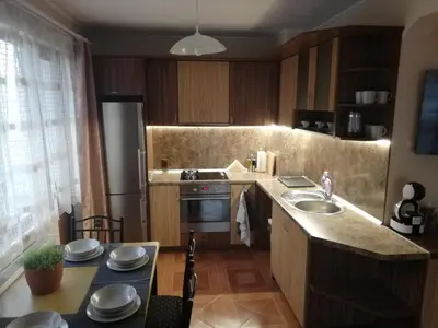 a kitchen with a sink and a stove top oven at Приключение в Триград in Trigrad