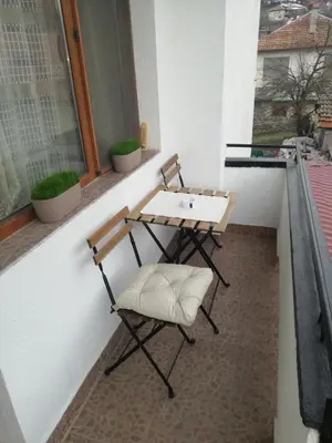 a table and chair sitting on a balcony at Приключение в Триград in Trigrad