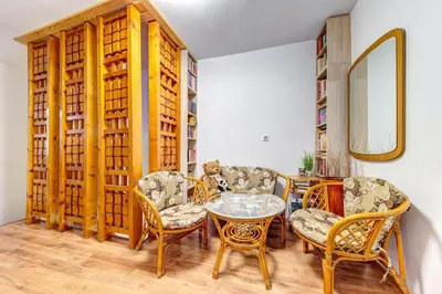 a room with chairs and a table and a mirror at Къща за гости Хаджиевата къща in Smolyan
