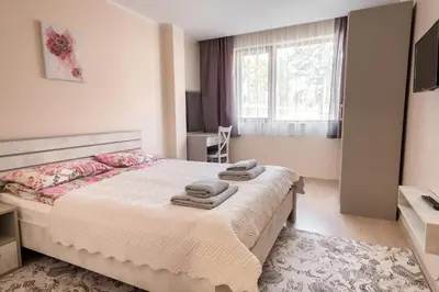 a bedroom with a bed with towels on it at Апартамент В4 in Velingrad