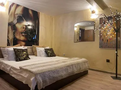 a bedroom with a large bed with a large painting on the wall at Paradise in the Mountain in Bansko