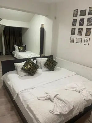 two beds in a room with towels on them at Paradise in the Mountain in Bansko