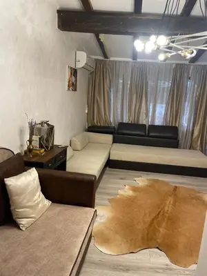 a living room with two beds and a couch at Paradise in the Mountain in Bansko