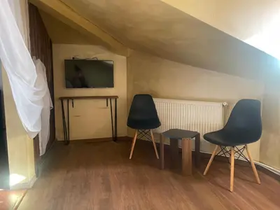 two chairs and a table in a room at Paradise in the Mountain in Bansko