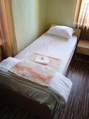 a bed in a room with a towel on it at KM!Sofia - Стаи за гости in Sofia
