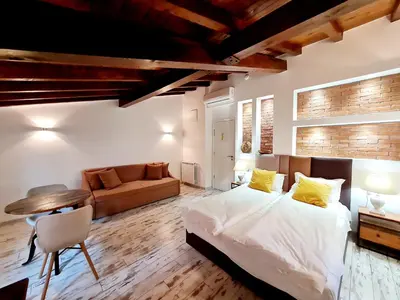 a bedroom with a large bed and a couch at Hotel House K21 in Sofia