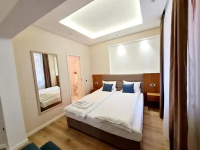 a bedroom with a bed and a large mirror at Hotel House K21 in Sofia