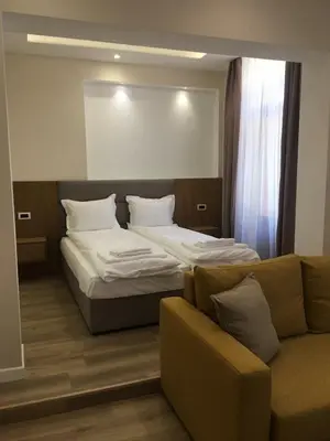 a bedroom with a bed and a couch at Hotel House K21 in Sofia