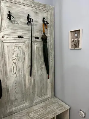 a wooden door with two umbrellas hanging on it at Diva Garden Apartment in Plovdiv