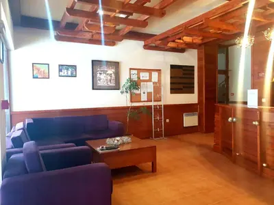 a living room with a blue couch and a table at Saint Ivan Ski Apartments in Bansko