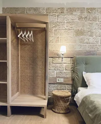 a bedroom with a bed and a brick wall at Къща за гости Volpe - Volpe Guesthouse in Oreshak