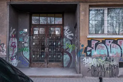 a door with graffiti on the side of a building at Industrial 2-BDR Flat by the National Stadium by Flat Mаnager in Sofia