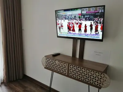 a flat screen tv sitting on a stand in a room at Azaria in Hisarya