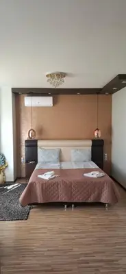 a bedroom with a large bed in a room at Fantasy Apartaments and studios Avenue комплекс Фантазия Хисаря in Hisarya
