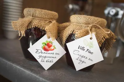 two bottles of strawberry jam with labels on them at Villa Pino in Velingrad