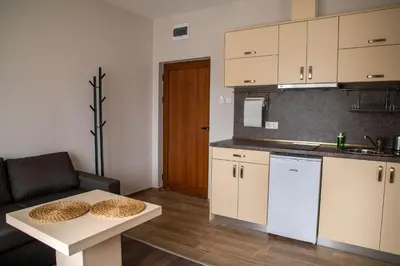 a kitchen with a couch and a table in a room at Червената къща in Perushtitsa