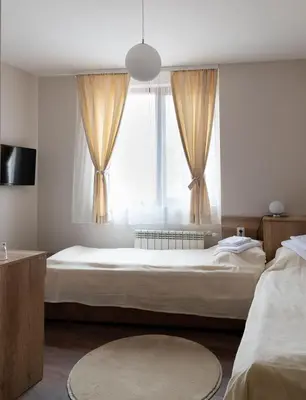 a bedroom with a large bed and a window at Червената къща in Perushtitsa