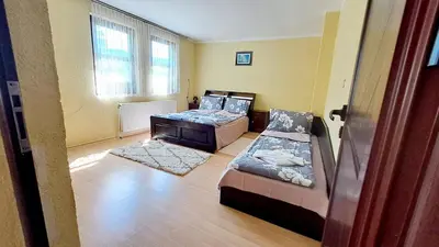 a living room with two beds and a couch at Авина къща in Kovachevitsa