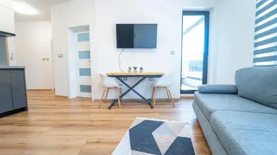 a living room with a couch and a table at Niko's Cozy Apartment in Plovdiv
