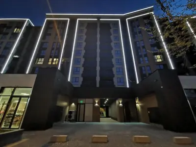 a tall building with lights on it at night at Niko's Cozy Apartment in Plovdiv