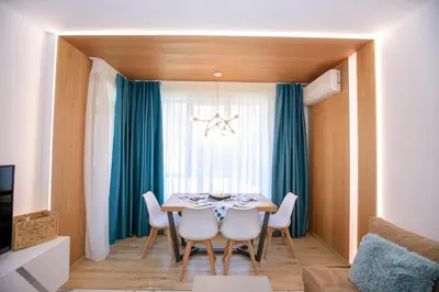 a dining room with a table and chairs at Лукс Апартамент Радост 2 in Sandanski